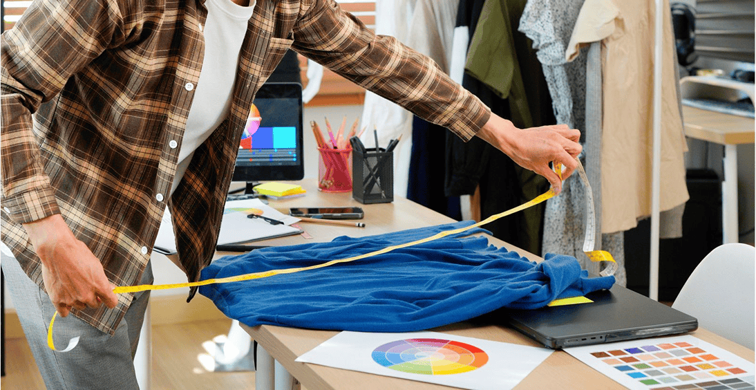 Designer working on clothing measurements.