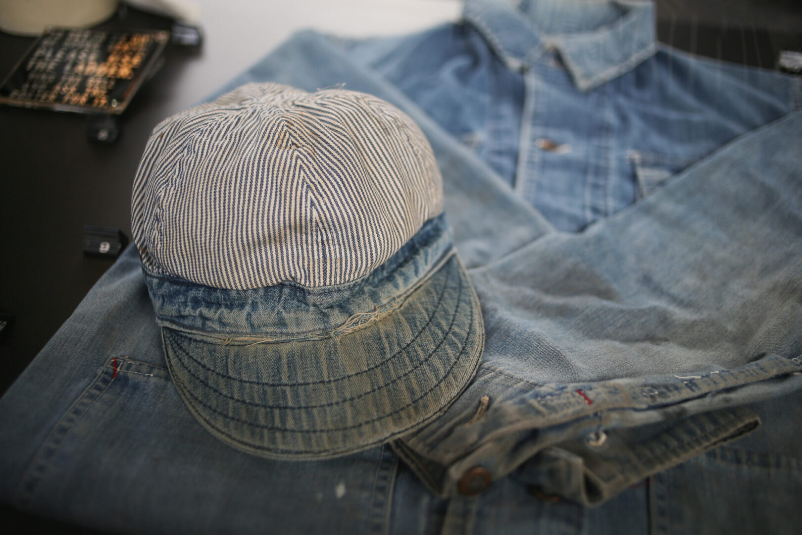 Striped cap on blue denim jacket